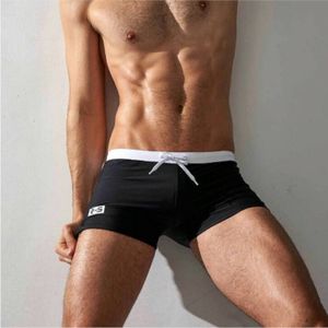 Фото Мужские плавки черные с белой резинкой оранжевым карманом сзади Aqux